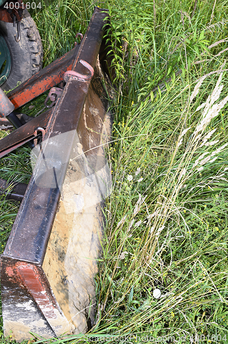 Image of Bulldozer, destroying the plants growing on soil