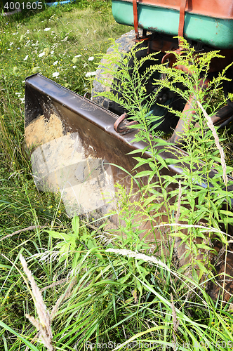 Image of Bulldozer, destroying the plants growing on soil