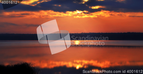 Image of Sunrise over the lake early in the morning with beautiful clouds