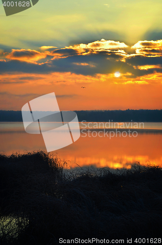 Image of Sunrise over the lake early in the morning with beautiful clouds