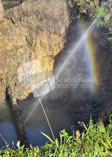 Image of The water jet in the form of leakage in the damaged metal pipe at the production site