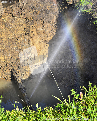 Image of The water jet in the form of leakage in the damaged metal pipe at the production site