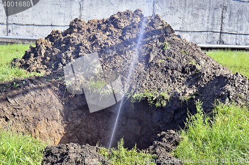 Image of The water jet in the form of leakage in the damaged metal pipe at the production site