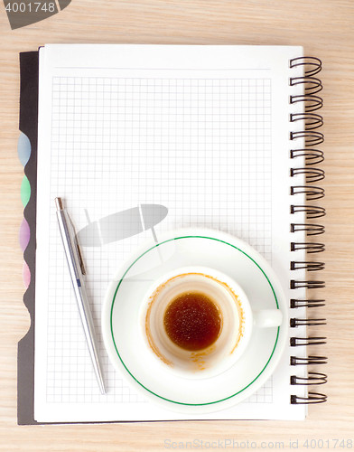 Image of blank page, empty cup of coffe, pen