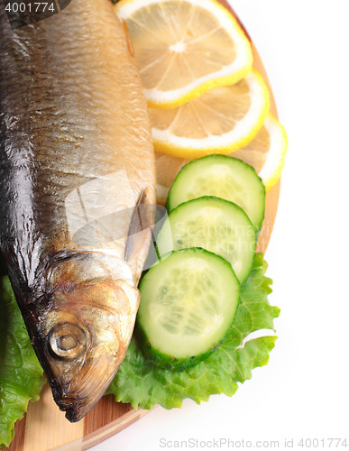 Image of fish with lemon and vegetables