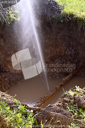 Image of The water jet in the form of leakage in the damaged metal pipe at the production site