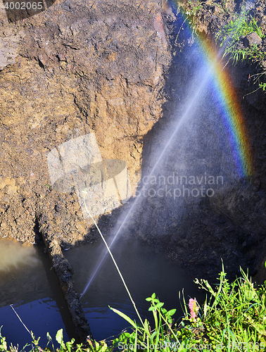 Image of The water jet in the form of leakage in the damaged metal pipe at the production site