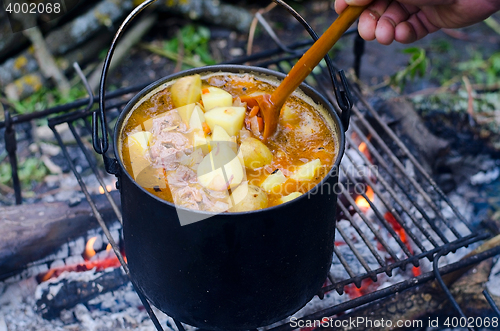 Image of The cooking of soup on the fire