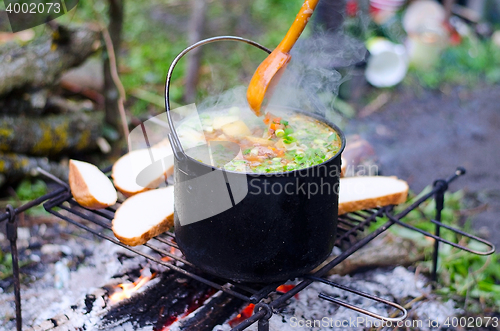 Image of The cooking of soup on the fire