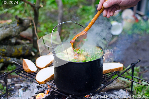 Image of The cooking of soup on the fire