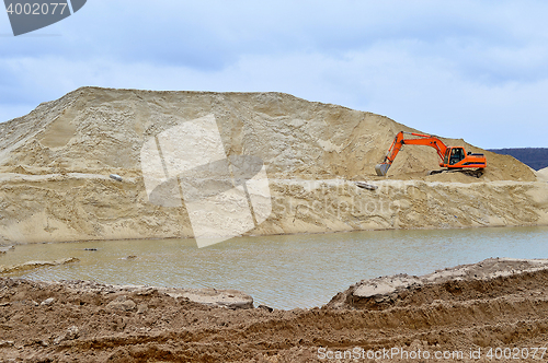 Image of Working digger in a quarry produces sand