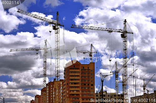 Image of  Construction site with cranes on sky background