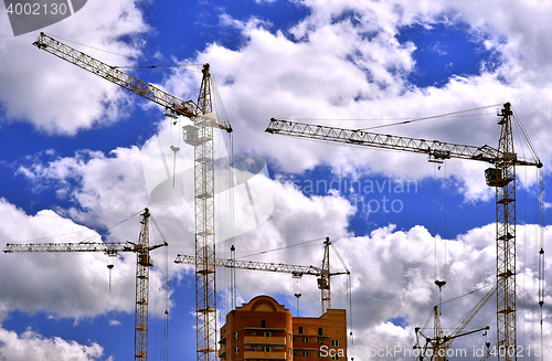 Image of  Construction site with cranes on sky background