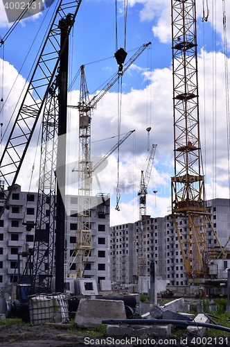 Image of  Construction site with cranes on sky background