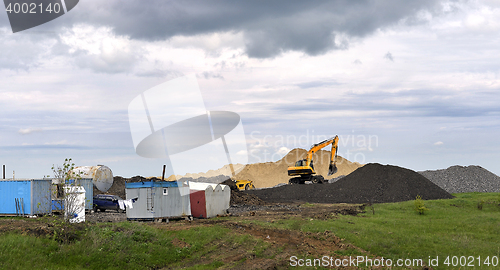 Image of  Yellow excavator working digging in sand quarry