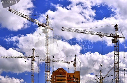 Image of  Construction site with cranes on sky background