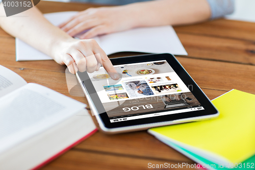 Image of close up of student with tablet pc and notebook