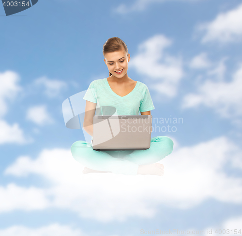 Image of happy young woman with laptop sitting on cloud