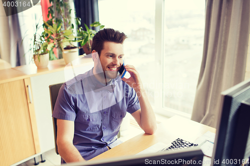 Image of happy creative male worker calling on smarphone