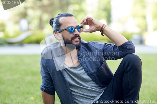 Image of man in sunglasses at city street or park