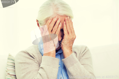 Image of senior woman suffering from headache or grief