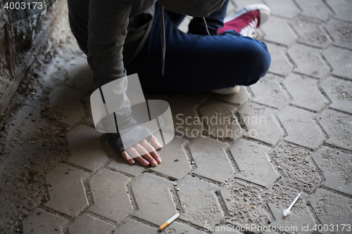 Image of close up of addict woman and drug syringes