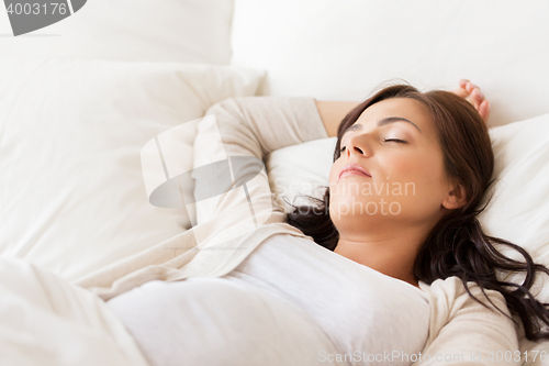 Image of happy pregnant woman sleeping in bed at home