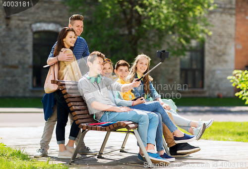 Image of happy teenage students taking selfie by smartphone