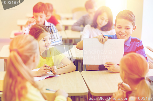 Image of group of school kids writing test in classroom