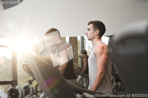 Image of group of men exercising on treadmill in gym