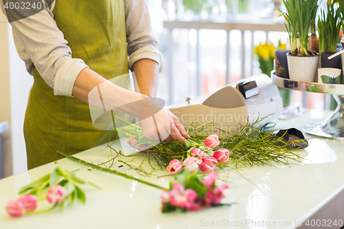 Image of close up of man making bunch at flower shop