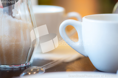 Image of cup with tea, spoon and sugar