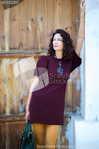 Image of attractive middle-aged woman in a burgundy dress 