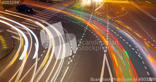 Image of crossroads with traces lights of cars at night