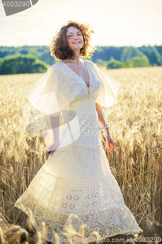 Image of Beautiful smiling woman dancing on the summer Field