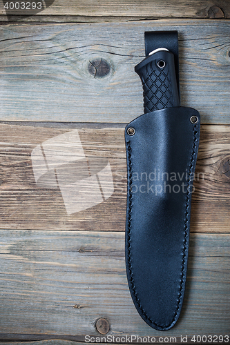 Image of hunting knife in a leather scabbard