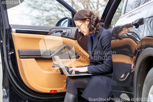 Image of business woman with a notebook on her lap