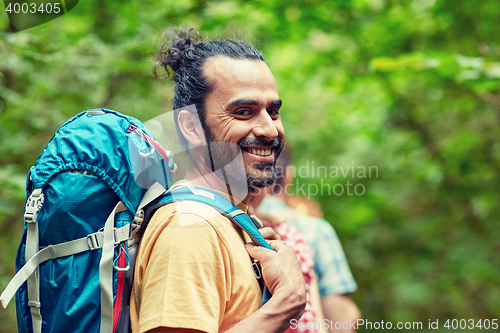 Image of group of smiling friends with backpacks hiking