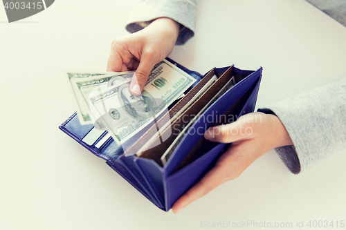 Image of close up of woman hands with wallet and money