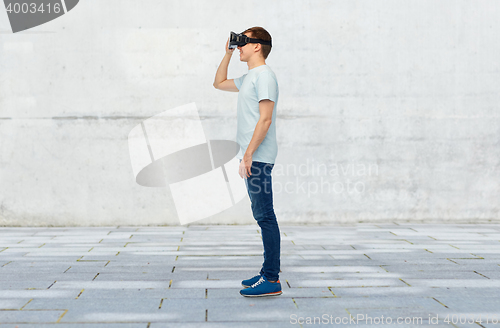 Image of happy man in virtual reality headset or 3d glasses