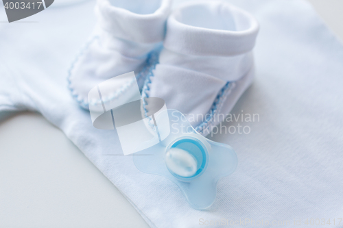 Image of close up of soother and baby clothes for newborn