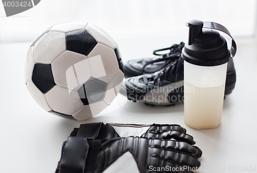 Image of close up of football boots, gloves and bottle