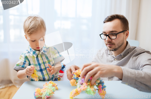 Image of father and son playing with ball clay at home