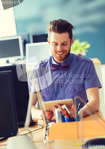Image of happy creative male office worker with tablet pc