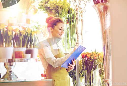 Image of florist woman with clipboard at flower shop