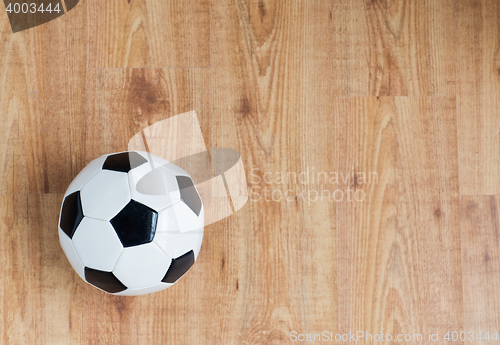 Image of close up of football or soccer ball on wood
