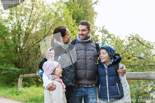 Image of happy family with backpacks hiking