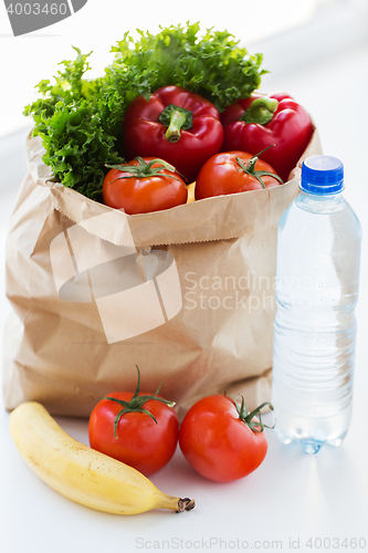 Image of close up of bag with friuts, vegetables and water