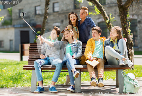 Image of happy teenage students taking selfie by smartphone