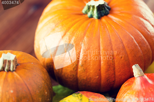 Image of close up of pumpkins on wooden table at home